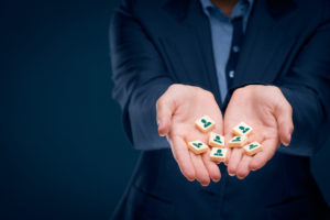 Hands holding icon tiles